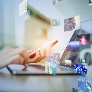 A person using their phone on top of a desk.