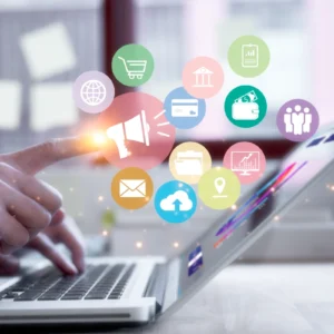 A person using a laptop with icons on the screen.