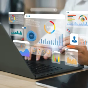 A person is using a laptop with graphs on it.